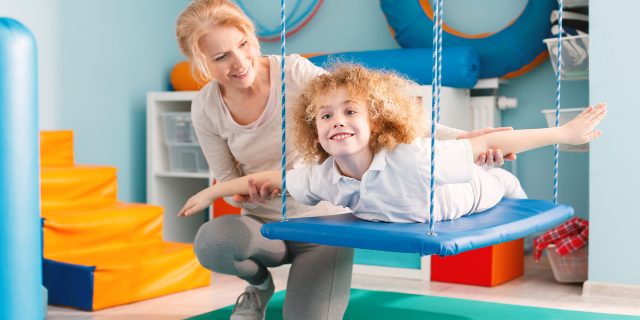 Boy on therapy swing